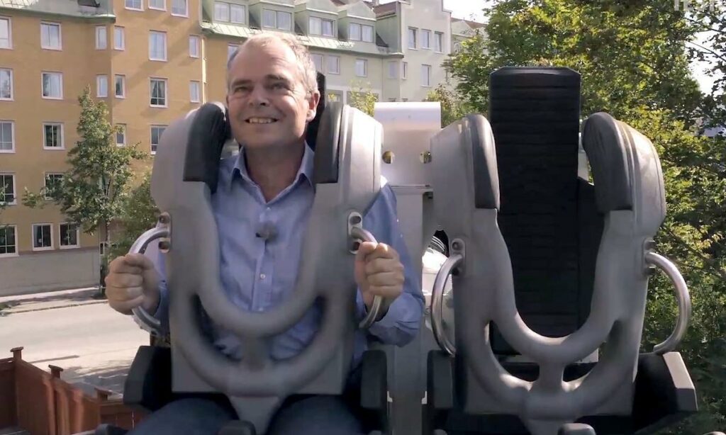En man sitter på en bilbänk i en park. (AI text)