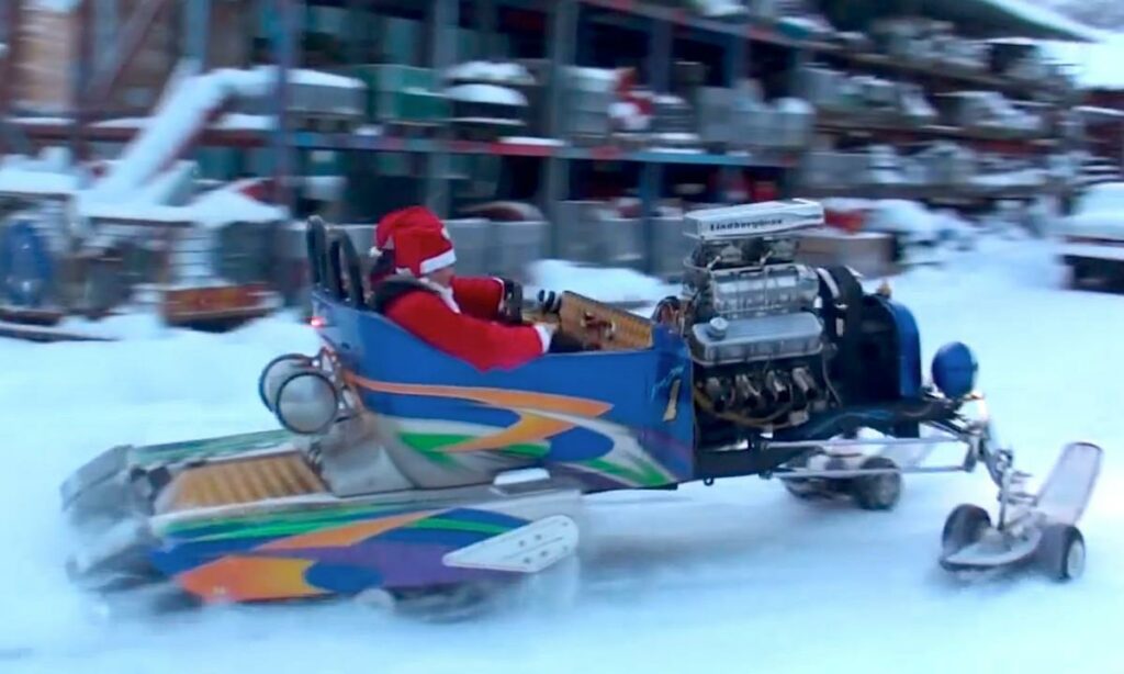 En person kör en snöskoter i snön. (AI text)