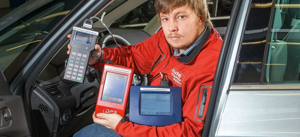 En man håller en surfplatta i sin bil. (AI text)