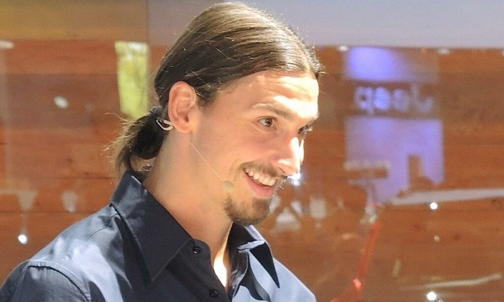 En man leder ett leende medan en kvinna håller en kamera. (AI text)