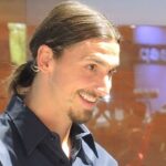 En man leder ett leende medan en kvinna håller en kamera. (AI text)