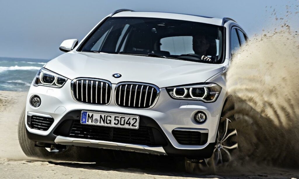BMW X1 kör på sandstrand (AI text)