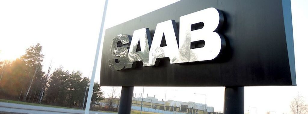 Saab-logotypen framför ett byggnad. (AI text)