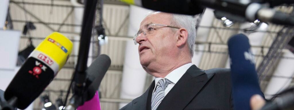 En man talar till journalister på en presskonferens. (AI text)