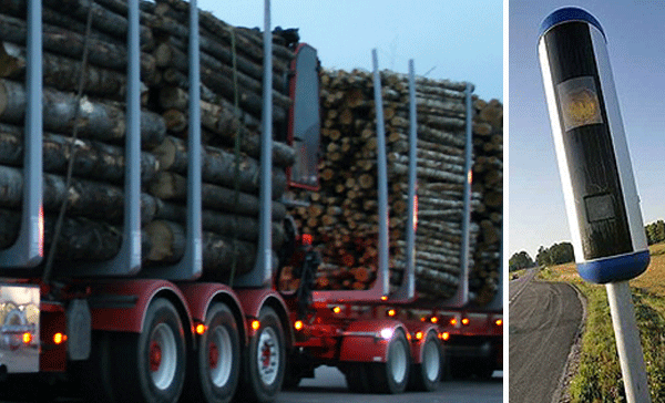 En lastbil kör nedför vägen med ett skylt på den. (AI text)