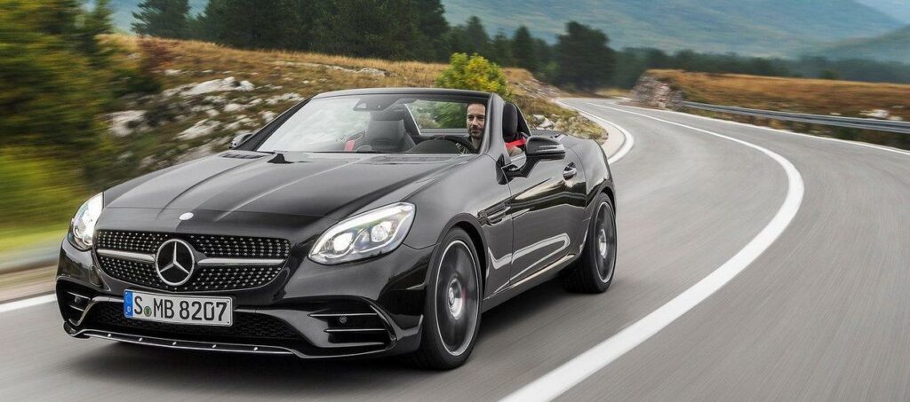 Mercedes SLK-klassen kör nedför en bergväg. (AI text)