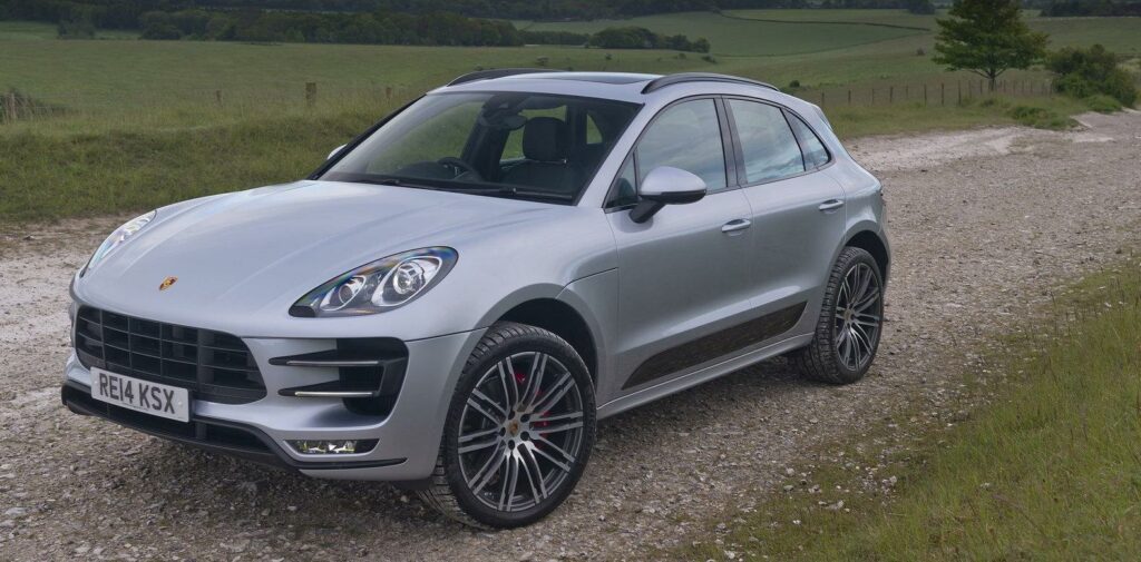 Porsche Macan parkerad på en grusväg. (AI text)