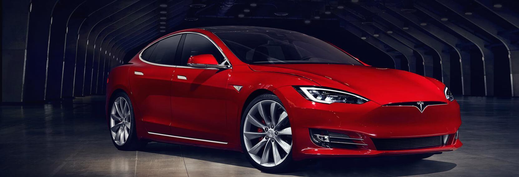 Tesla Model S parkerad i en mörk garagerom (AI text)