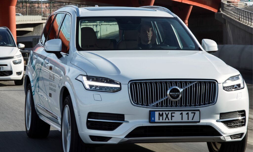 En Volvo XC90 SUV kör på en bro. (AI text)