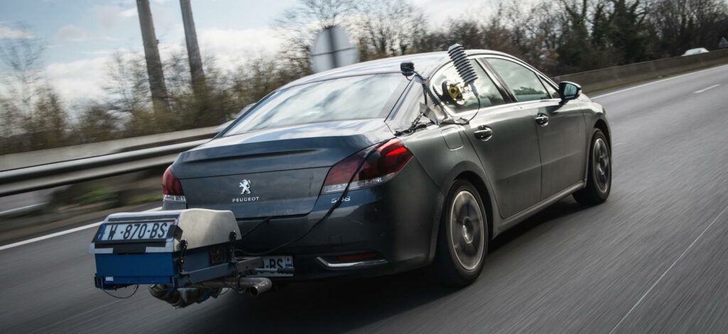 En bil kör nedför en motorväg med en släp upphängd bakom. (AI text)