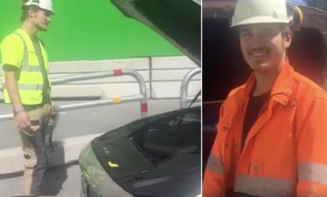 En man i orange säkerhetsväst och orange huvudsäkerhetsboll står bredvid en bil. (AI text)