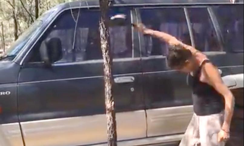 En kvinna står bredvid en bil. (AI text)