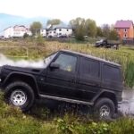 En man står bredvid en jeep. (AI text)