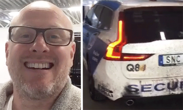 En man i glasögon står bredvid en polisbil. (AI text)