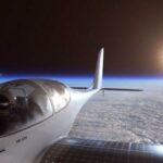 En solpaneluppslagen plan flyger över jorden. (AI text)