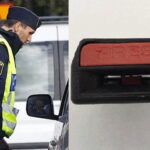 En polis i en polisbil med en annan polisbil i bakgrunden. (AI text)