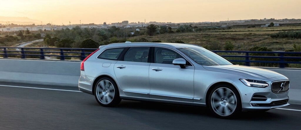 Volvo V90 Xdrive vagn kör längs vägen. (AI text)