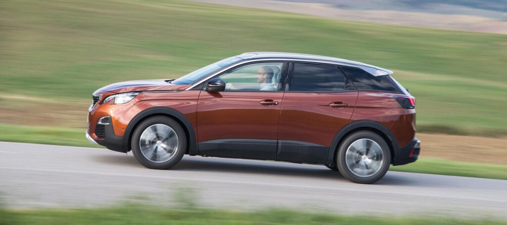 En bil kör genom landsbygden längs en landsväg. (AI text)