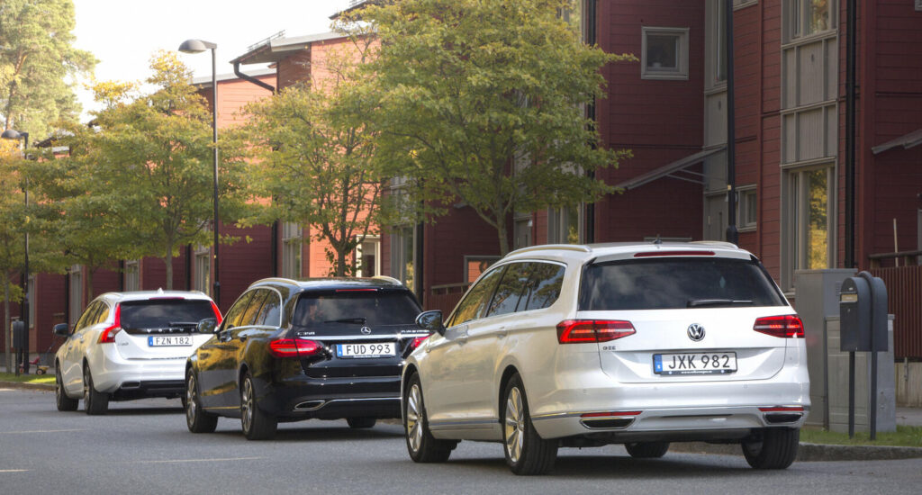 En grupp bilar parkerade vid en gata. (AI text)