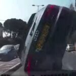 En bil ligger uppochnersad i en parkeringsplats. (AI text)