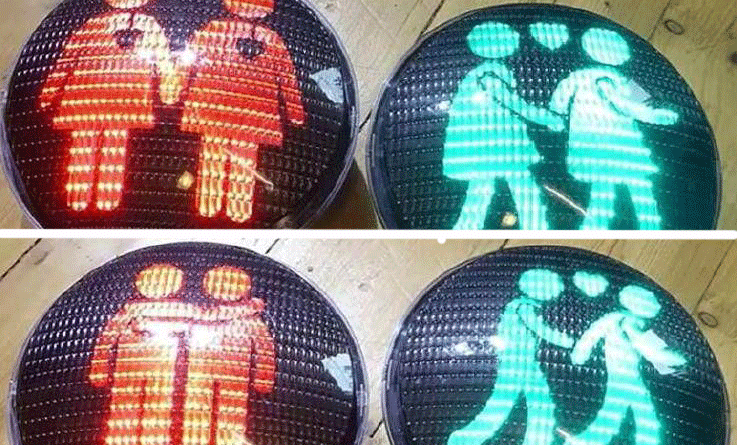 En trafikljus med några personer på den (AI text)