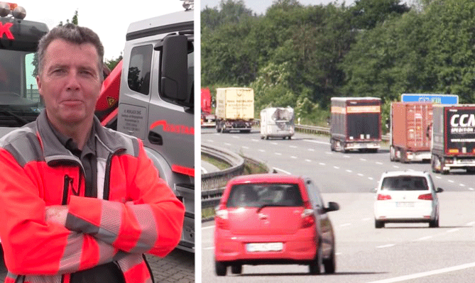 En man i gult västar står bredvid en lastbil på en motorväg. (AI text)