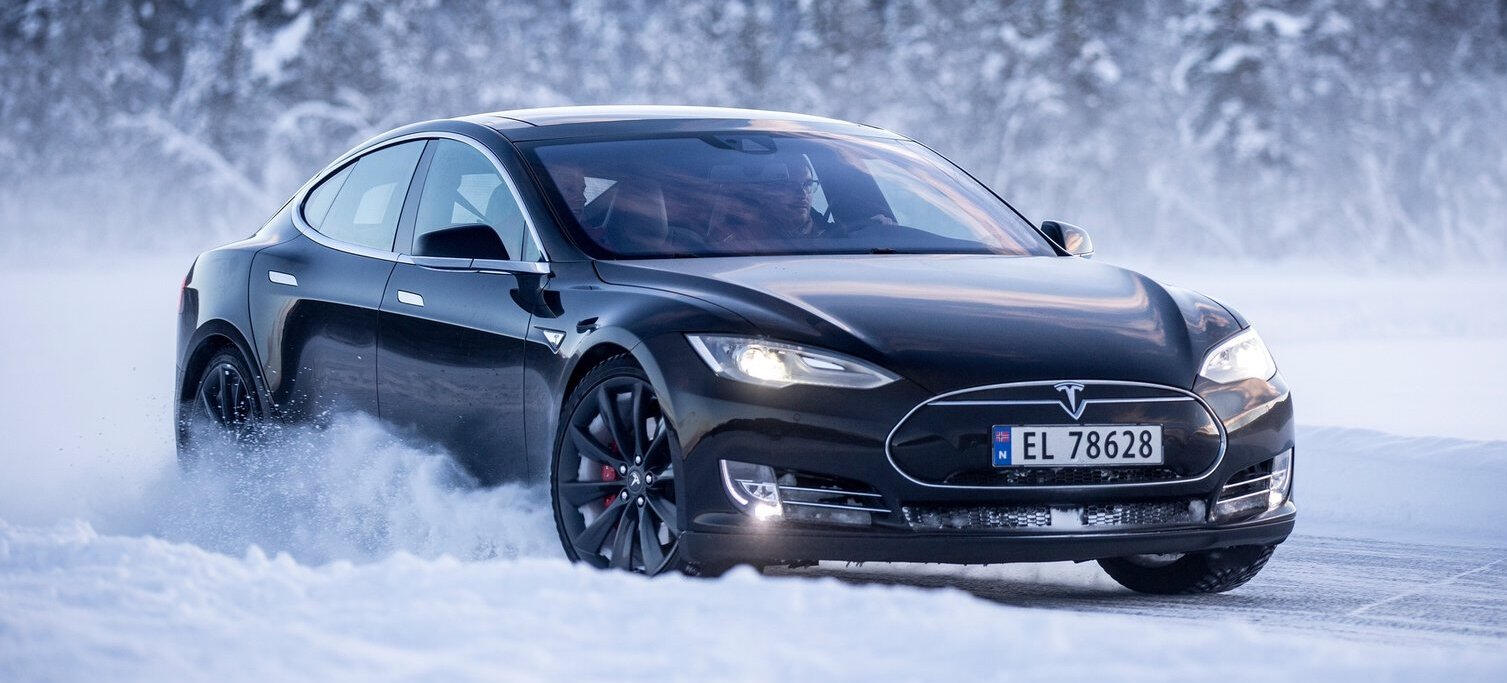 Tesla Model S kör i snö. (AI text)