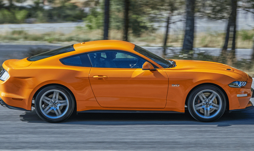 En Ford Mustang GT kör längs en väg. (AI text)