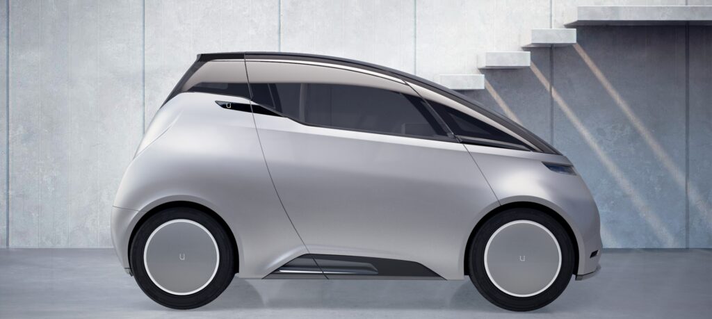 En framtida bil parkerad framför trappan. (AI text)