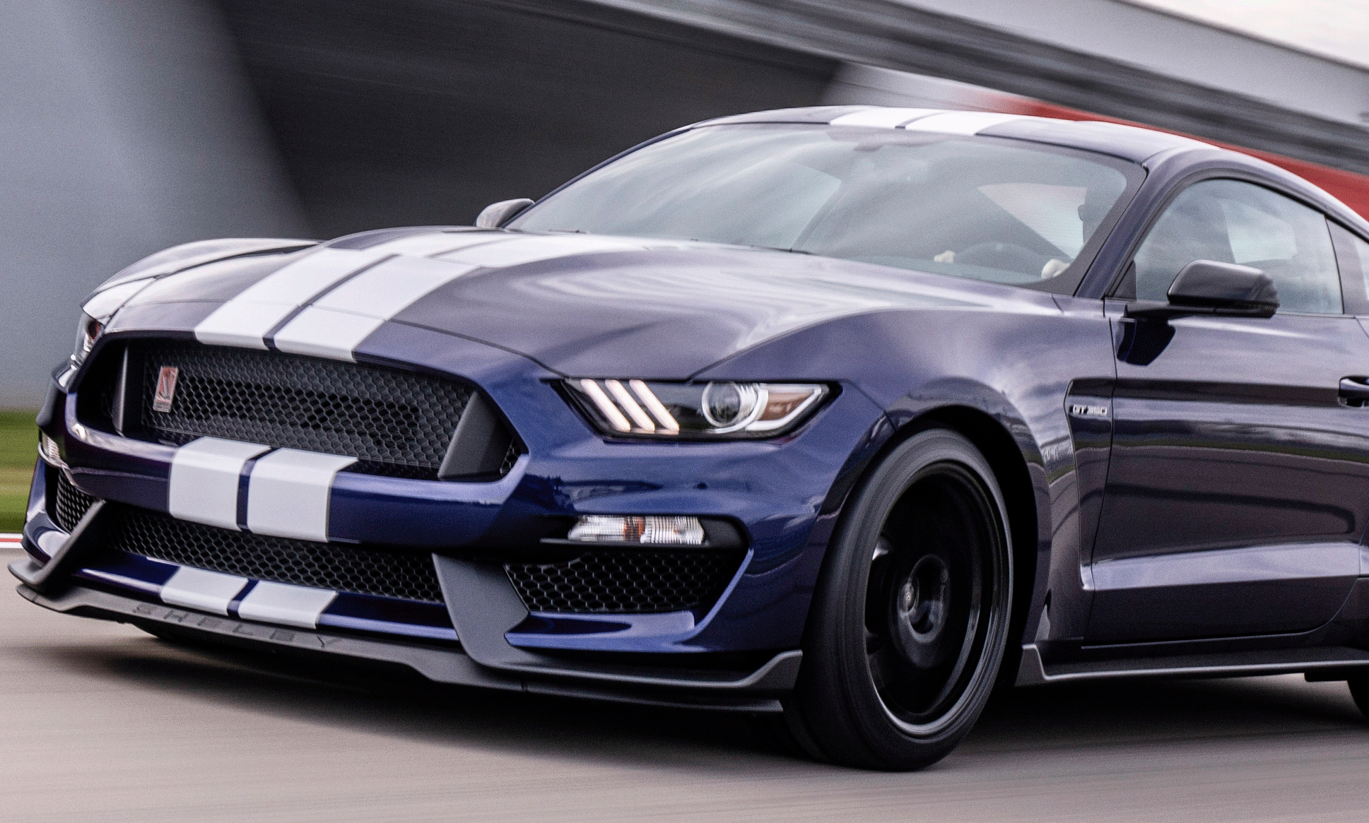 Den 2019 års Ford Mustang GT kör på en racingbana. (AI text)