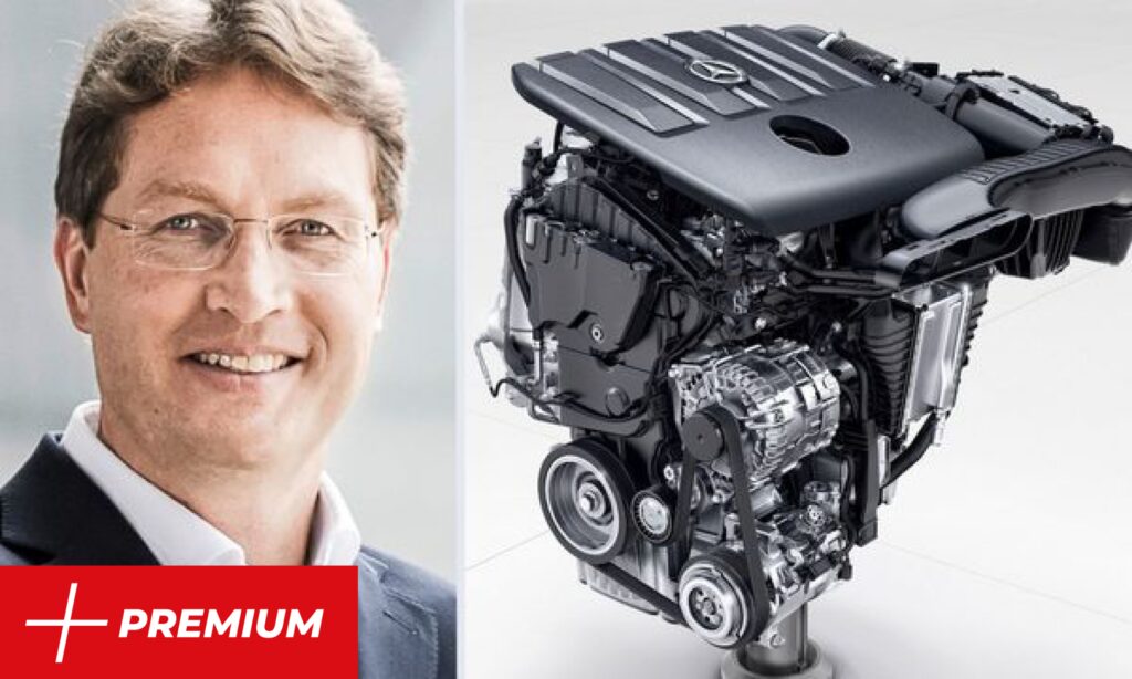 En man i kostym och slips står bredvid en bilmotor. (AI text)