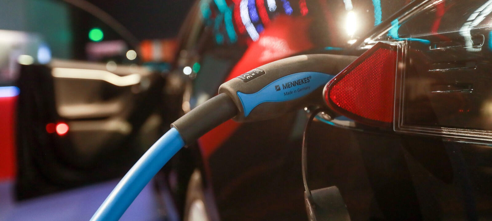 En bil är uppkopplad till en elladdare. (AI text)