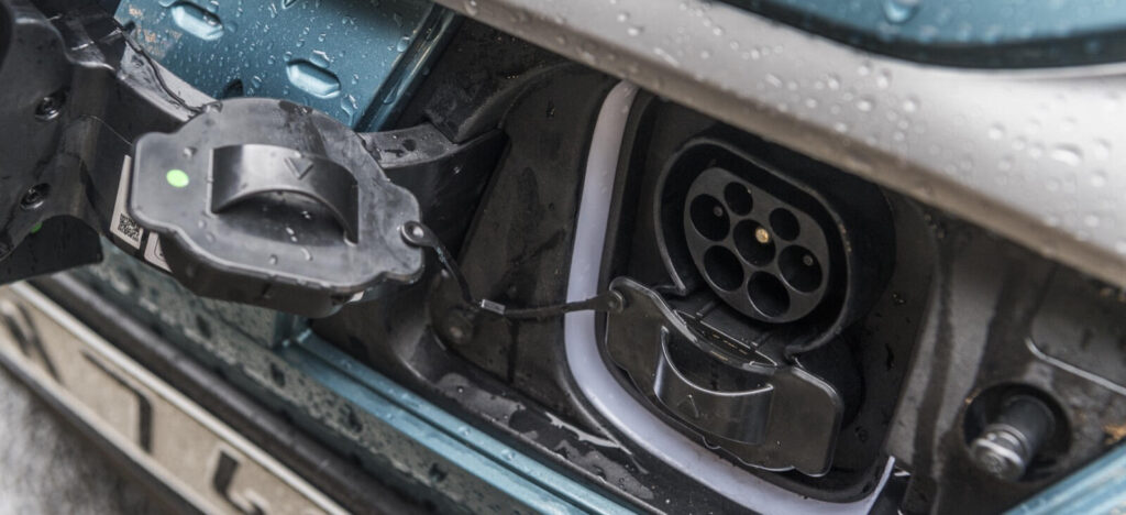 En bil är uppkopplad till en elladdare. (AI text)