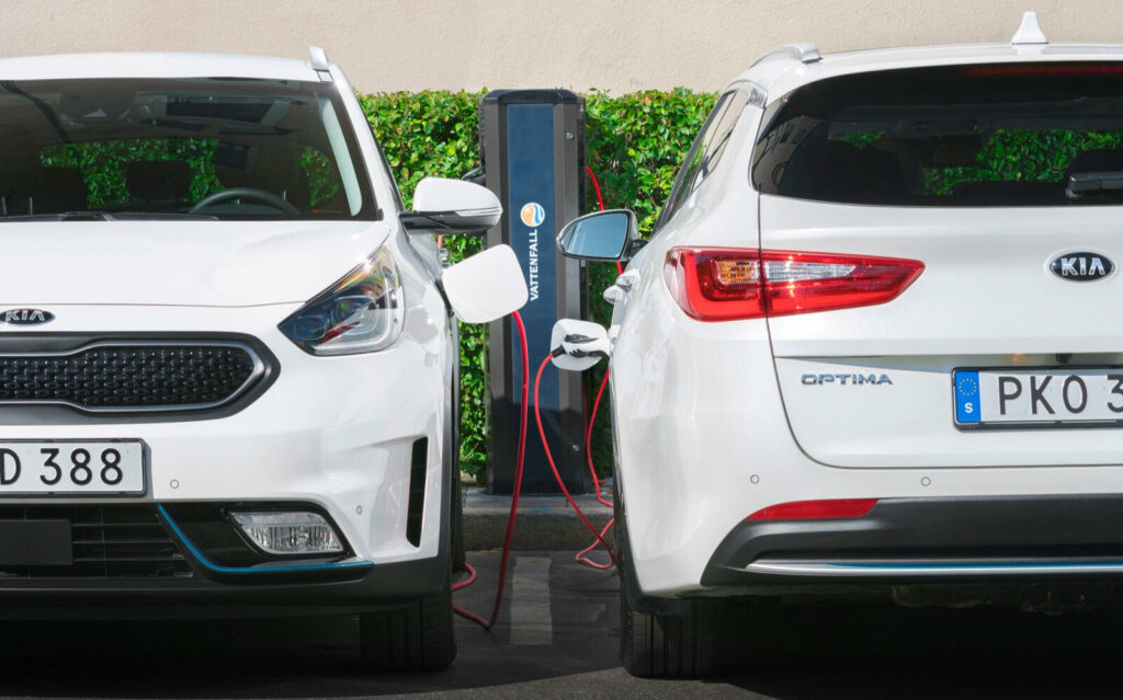 Två elbilar parkerade bredvid varandra. (AI text)