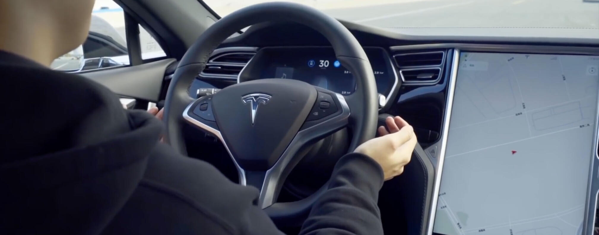 En man kör en Tesla Model S. (AI text)