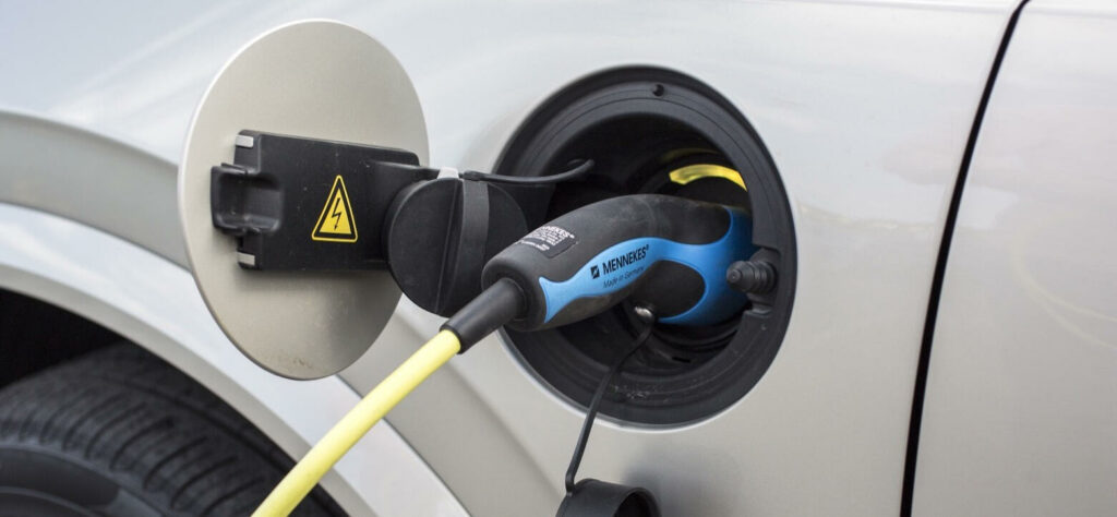 En bil är uppkopplad till en elladdare. (AI text)