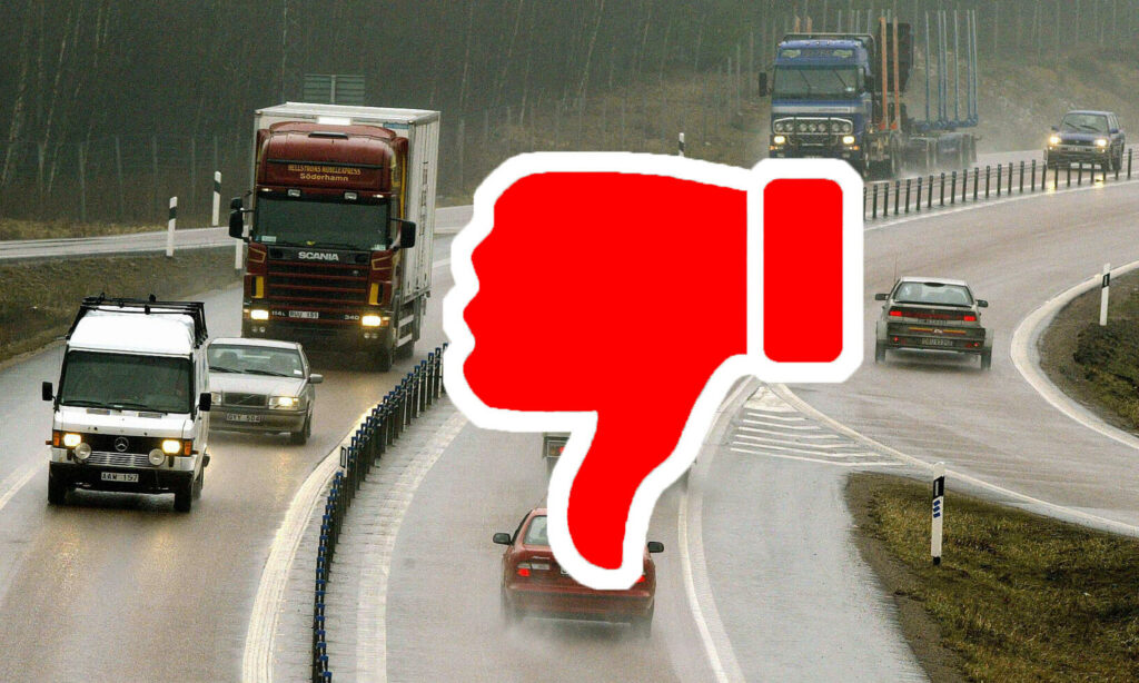 En bil på en högtrafik med en röd pekfinger nedåt tecken. (AI text)