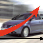 En bil kör nerför en väg med en pil som pekar uppåt. (AI text)