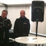 En grupp personer står i en tält. (AI text)