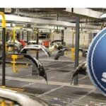 Saab-logotypen syns tydligt på bilen i fabriken. (AI text)