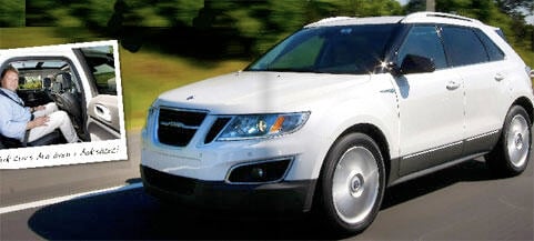 En vit bil körer ner vägen med en man i förarsätet. (AI text)