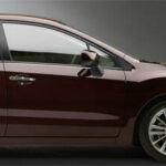 En röd Subaru Impreza parkerad i en studio. (AI text)