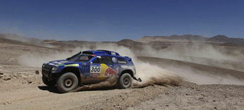 En blå och vit terrängbil kör genom öken. (AI text)