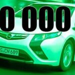 En vit bil körer nerför gatan med orden 5000 kr. (AI text)