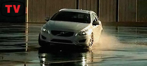 En Volvo V40 kör i en regnig parkeringsplats. (AI text)