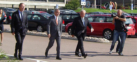 En grupp personer går i en parkeringsplats. (AI text)