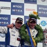 En grupp personer på en podiet med en bil. (AI text)