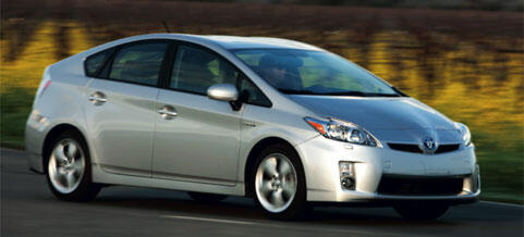 En silverfärgad Toyota Prius kör längs en landsväg. (AI text)