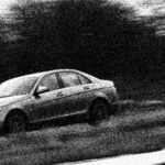 En Mercedes-Benz C-klass kör på en racerbana. (AI text)