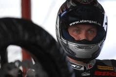 En motorcykelsnubb stramar till sin motorcykel inför loppet. (AI text)